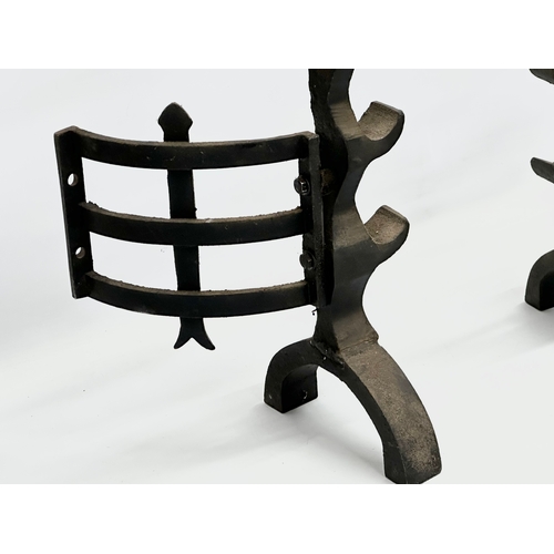 81 - A pair of large 17th Century style cast iron fire andirons. 23x56cm