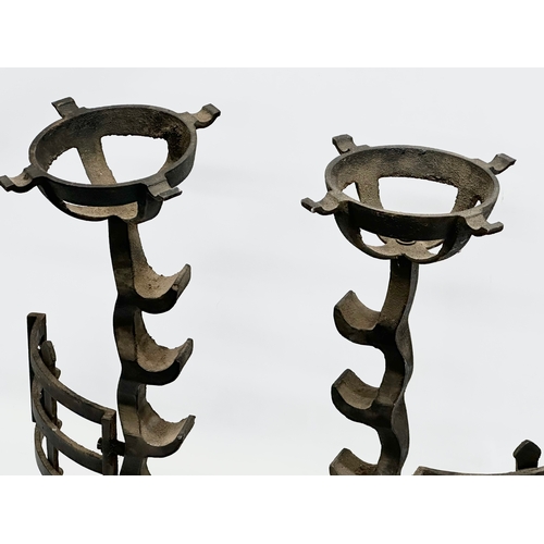 81 - A pair of large 17th Century style cast iron fire andirons. 23x56cm