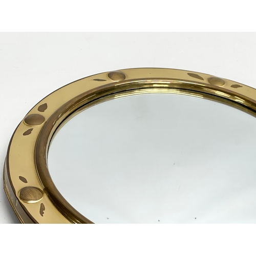 422 - A Mid 20th Century brass framed ships porthole style convex mirror. 30cm