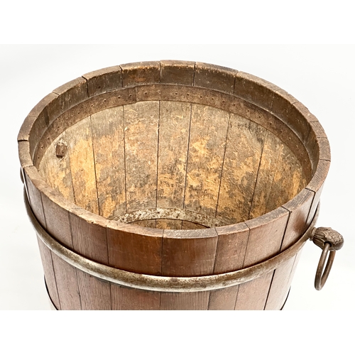 117 - A large Late 19th Century oak coal bucket with large drop ring handles. Circa 1880-1900. 53x45x43.5c... 