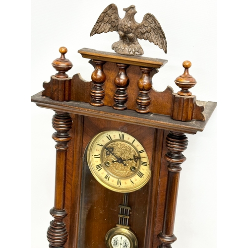 111 - A Late 19th Century Victorian spring Vienna wall clock. With key and pendulum. 34x82cm