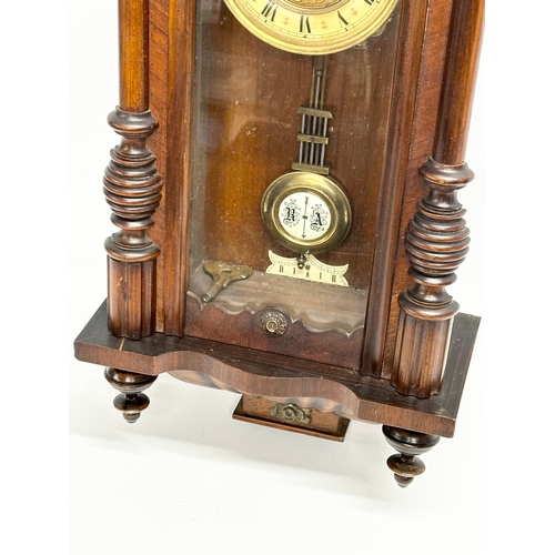 111 - A Late 19th Century Victorian spring Vienna wall clock. With key and pendulum. 34x82cm