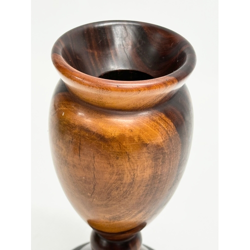 9 - A 19th Century turned wooden Lignum Vitae vase. 18.5cm