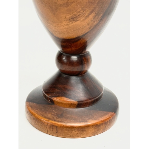 9 - A 19th Century turned wooden Lignum Vitae vase. 18.5cm