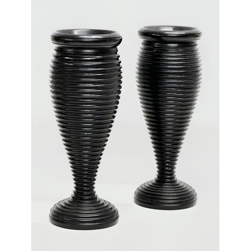 10 - A pair of Late 19th Century turned ebony candleholders/vases. 16cm.