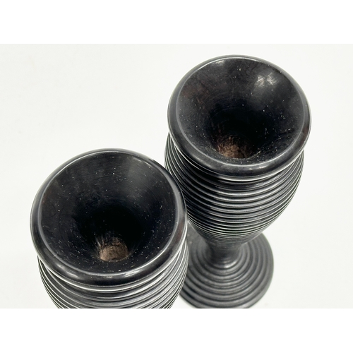 10 - A pair of Late 19th Century turned ebony candleholders/vases. 16cm.