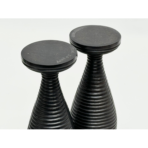 10 - A pair of Late 19th Century turned ebony candleholders/vases. 16cm.