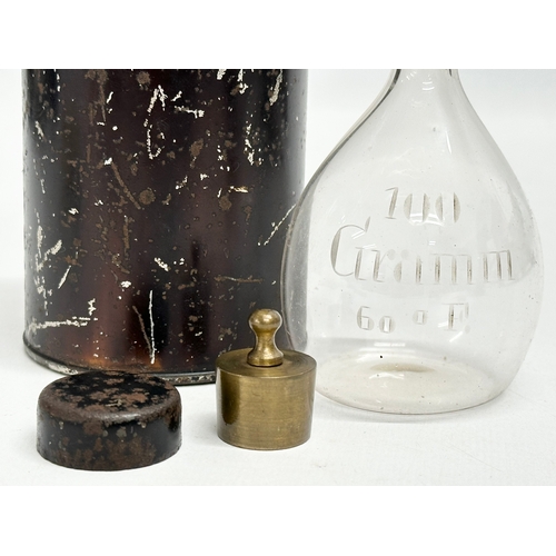 19 - An Early/Mid 19th Century apothecary glass bottle with original tin and weight in lid. 15cm