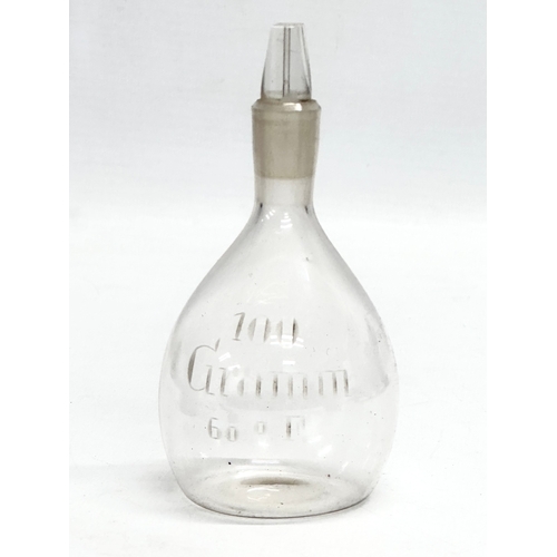 19 - An Early/Mid 19th Century apothecary glass bottle with original tin and weight in lid. 15cm