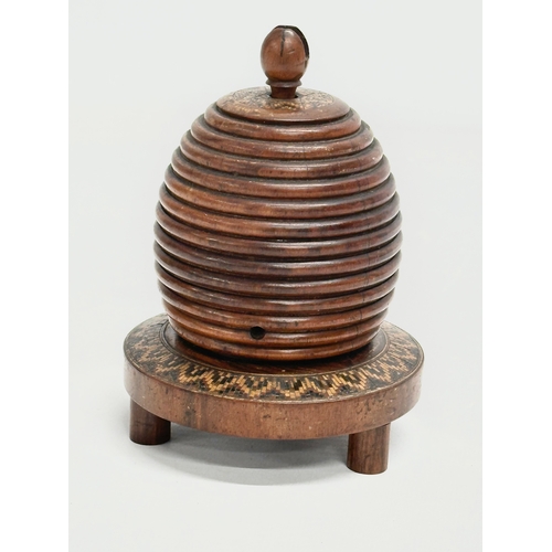 13 - A Mid 19th Century Lignum Vitae turned fruitwood beehive string box. 9x12cm