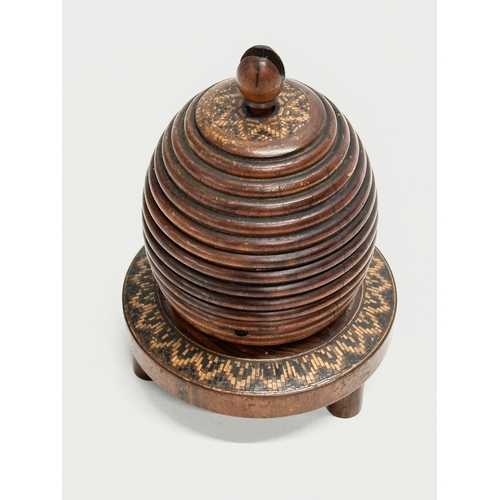 13 - A Mid 19th Century Lignum Vitae turned fruitwood beehive string box. 9x12cm