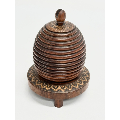 13 - A Mid 19th Century Lignum Vitae turned fruitwood beehive string box. 9x12cm