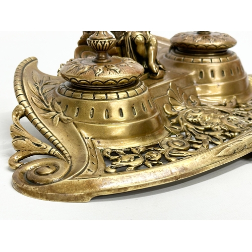 37 - A Late 19th Century brass inkstand/inkwell with sitting putti and pierced brass base. 32x20x11cm