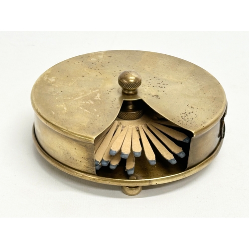 118 - A Late 19th/Early 20th Century brass revolving match striker. 12x5cm