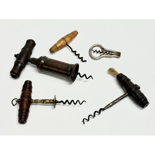 39 - A good collection of 19th Century corkscrews with turned handles. A large barrel shaped corkscrew 18... 