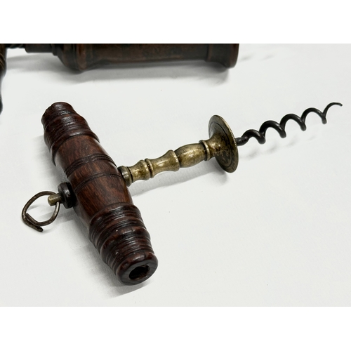 39 - A good collection of 19th Century corkscrews with turned handles. A large barrel shaped corkscrew 18... 