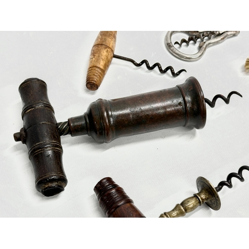 39 - A good collection of 19th Century corkscrews with turned handles. A large barrel shaped corkscrew 18... 