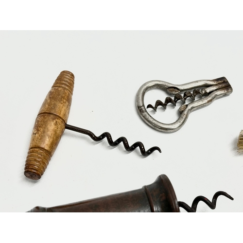 39 - A good collection of 19th Century corkscrews with turned handles. A large barrel shaped corkscrew 18... 