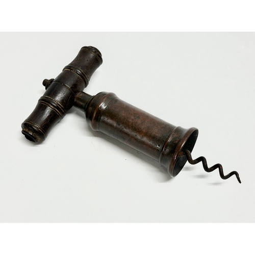 39 - A good collection of 19th Century corkscrews with turned handles. A large barrel shaped corkscrew 18... 