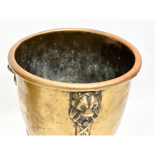 15 - A pair of Mid/Late 19th Century brass jardinières/planters raised on 3 lion paw feet and copper stud... 