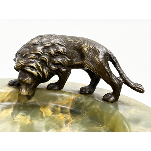 198 - An Early 20th Century onyx ashtray with bronze lion. 12x12cm