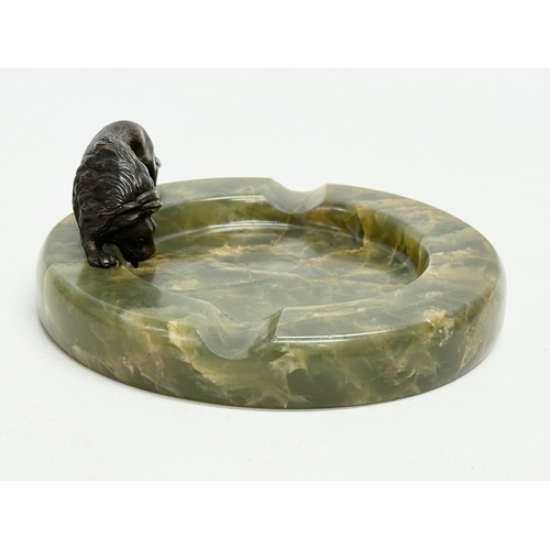 198 - An Early 20th Century onyx ashtray with bronze lion. 12x12cm