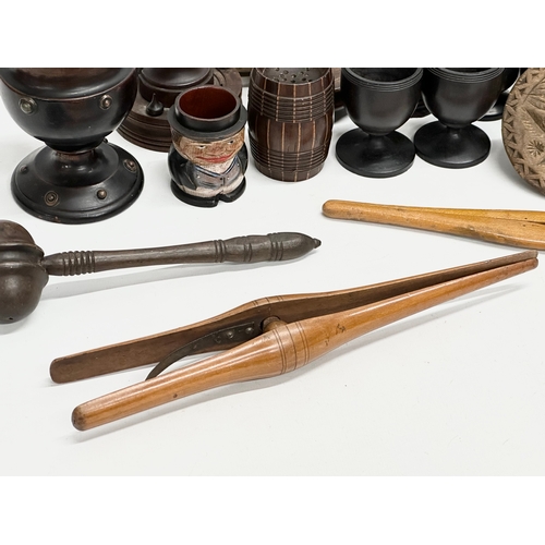 202 - A collection of 19th Century Treen Ware. Salt shaker, egg cups, butter pat, pestle etc