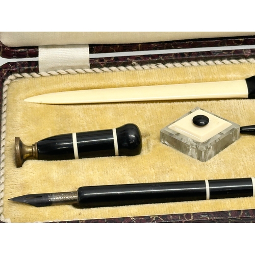 217 - An Early 20th Century pen set in case. With a C. Brandauer nib. Inkwell, seal, fountain pen, letter ... 