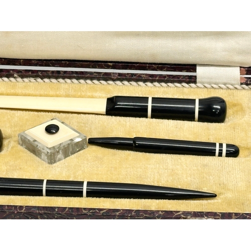 217 - An Early 20th Century pen set in case. With a C. Brandauer nib. Inkwell, seal, fountain pen, letter ... 