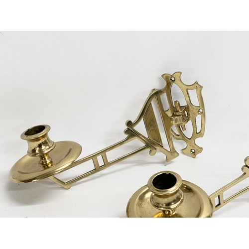 219 - A pair of Early 20th Century brass harp design wall mounted candleholders. 22cm