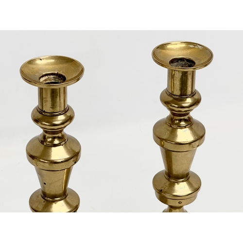 223 - A pair of large Victorian brass candlesticks. 27cm