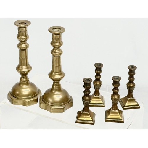 224 - 5 sets of Victorian brass candlesticks. 3 pairs and 2 sets of 4. 12cm, 11cm, 11.5. 6cm