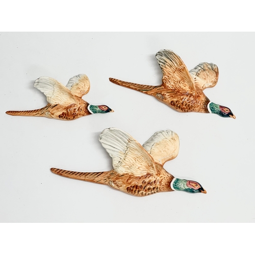 418 - A set of 3 Beswick flying pheasant wall plaques. Largest 30cm