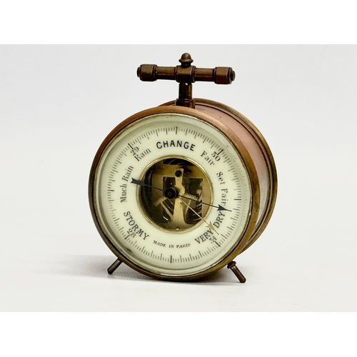 238 - A Late 19th/Early 20th Century French brass cased barometer. Made in Paris. Circa 1900. 8x5x9.5cm