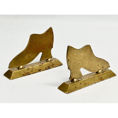 195 - Victorian brassware. A pair of Victorian brass fireplace stands with a pair of Victorian brass taps.