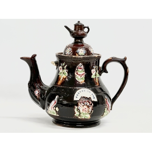 58 - A large Late 19th Century Measham Pottery ‘Bargeware’ teapot. Circa 1880-1890. Forget Me Not. 35x21x... 