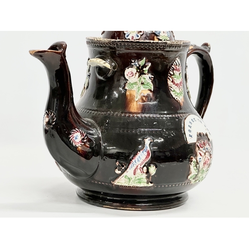 58 - A large Late 19th Century Measham Pottery ‘Bargeware’ teapot. Circa 1880-1890. Forget Me Not. 35x21x... 