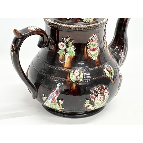 58 - A large Late 19th Century Measham Pottery ‘Bargeware’ teapot. Circa 1880-1890. Forget Me Not. 35x21x... 