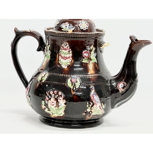 58 - A large Late 19th Century Measham Pottery ‘Bargeware’ teapot. Circa 1880-1890. Forget Me Not. 35x21x... 