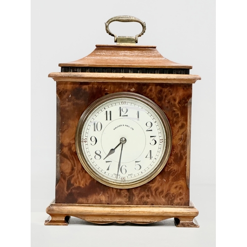 261 - An Early 20th Century Walker & Hall burr walnut mantle clock. French works. 16x8x21cm