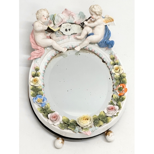 267 - A Late 19th Century German porcelain framed dressing mirror. 21x32cm