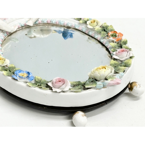 267 - A Late 19th Century German porcelain framed dressing mirror. 21x32cm