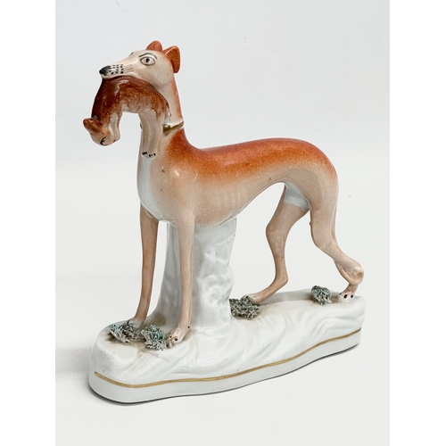 268 - A pair of Late 19th Century Staffordshire whippets. 18x19cm