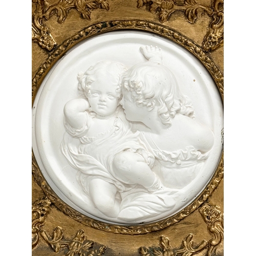 287 - A gilt framed ‘Children at Play’ wall plaque. 28x27.5cm