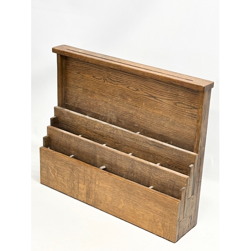 308 - An Early 20th Century oak wall mounted paper rack. 61x14x49.5cm