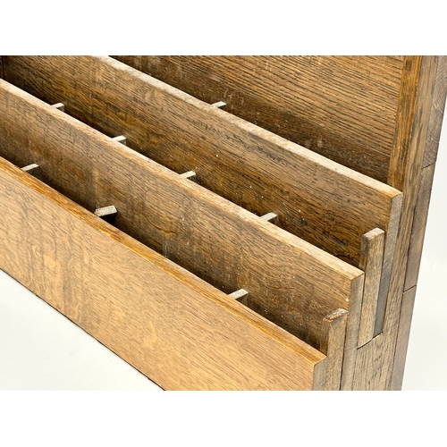 308 - An Early 20th Century oak wall mounted paper rack. 61x14x49.5cm