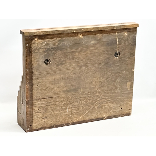 308 - An Early 20th Century oak wall mounted paper rack. 61x14x49.5cm