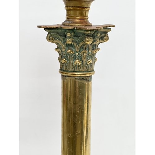 320 - A large Victorian Ruby glass oil lamp with brass Corinthian style column. 60cm