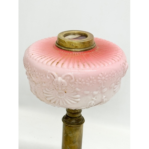 321 - A Victorian embossed milk glass oil lamp with brass column. 35cm