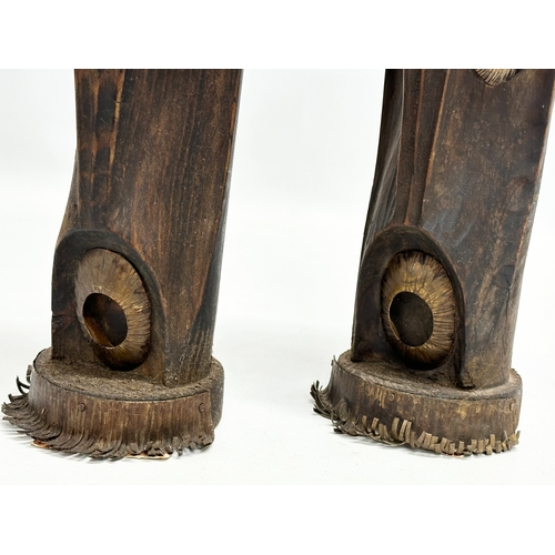 325 - A pair of 20th Century African style wood and brass candleholders. 30cm